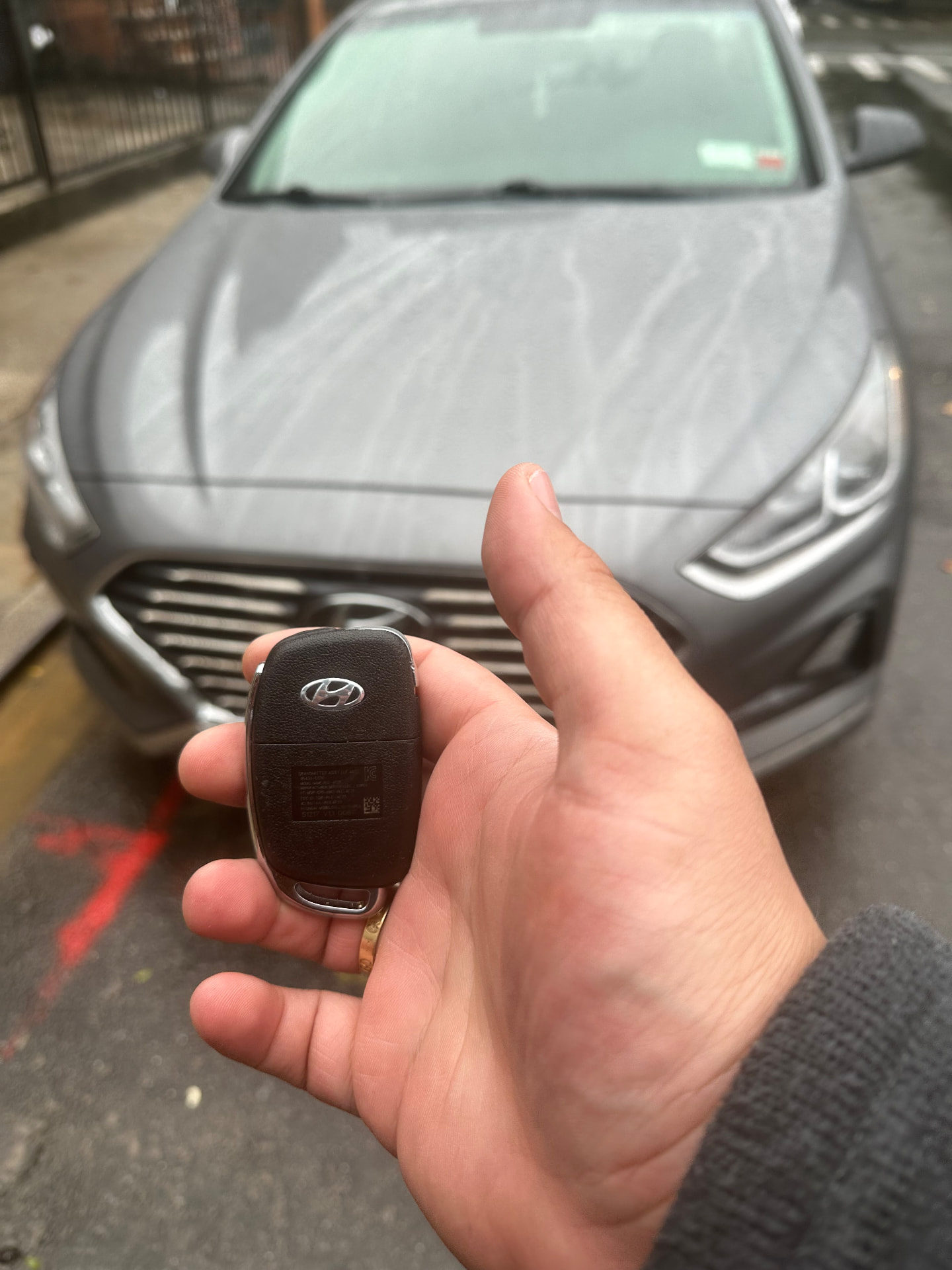New Hyundai flip key held in front of a Hyundai Sonata after an all-keys-lost job